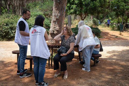 Jamila, 50, speaks with a medical staff at MSF’s mobile clinic of Horsh Park, Beirut, Lebanon, on 21 May 2026.

Displaced from Meiss al-Jabal, she spent two months living in tents in Dahye before learning about MSF's free healthcare services. She was forced to leave her home without any support and went days without enough food, even having to ask for help to feed her 14-year-old son Wissam, who has a speech impairment.

"My son asked for food, and I told him I had no money to feed him. What should I do?" she says. "No one cares about me. I went days without food or water. I could not even bathe.”