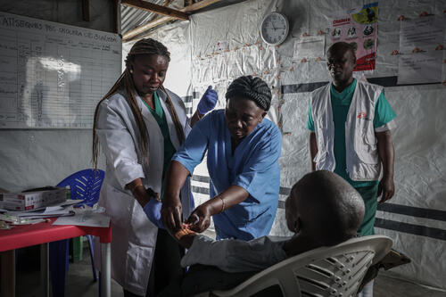 Medical staff take care of a patient at the Buhimba cholera treatment centre in Goma, North Kivu.