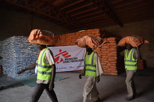 Staff at MSF warehouse carrying food items to the truck in order to transport to food distribution site in Nyala/South Darfur