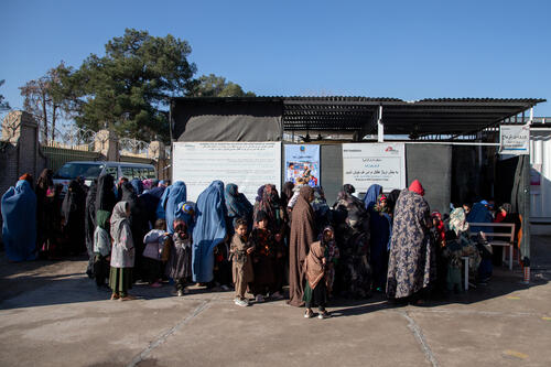 Mothers and their children are queuing outside the triage waiting room for their children to be seen by medical staff. There are many patients already inside the waiting room so they have to wait outside. MSF teams in the triage often see more than 1,000 patients in a day.