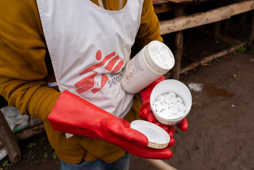 An MSF employee shows purification tablets used to generate a clean water supply for the population of Lomera, a mining town in South Kivu grappling with a cholera outbreak.