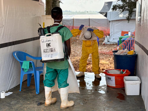 A hygiene worker removes his protective suit in the doffing area of the MSF ETC at Bambu General Referral Hospital.