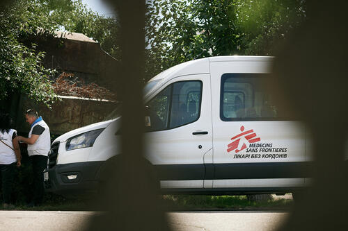 View of an MSF vehicle in In Chornomorka, Mykolaiv region, where a mobile clinic of MSF comes twice a month.  

The team includes a therapist, a gynecologist, a psychologist, and a health promoter. There is a long queue in each cabinet. While people are waiting, the Health Promotion specialist talks about the importance of following a diet for hypertension and diabetes, the difference between moderate physical activity and working in rural areas. 

 “Today we talked to patients about hypertension and did some sitting exercises together. We also held a session on sleep with a psychologist. This community is less than 15 km from the frontline, and residents constantly hear loud shelling, or rocket launches, drones that fly over their homes every night. This causes anxiety, mental problems, and difficulty sleeping,” explains Hanna Udovychenko, Health Promotion  supervisor.