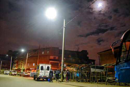 An MSF ambulance picking up a patient at night in Mathare