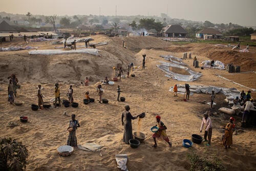 People work in a rice mill located at Makurdi town