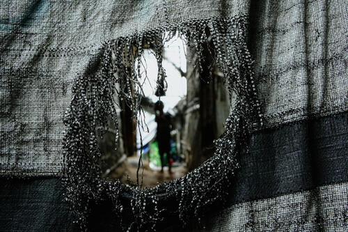 9 A young child seen through the tarpaulin