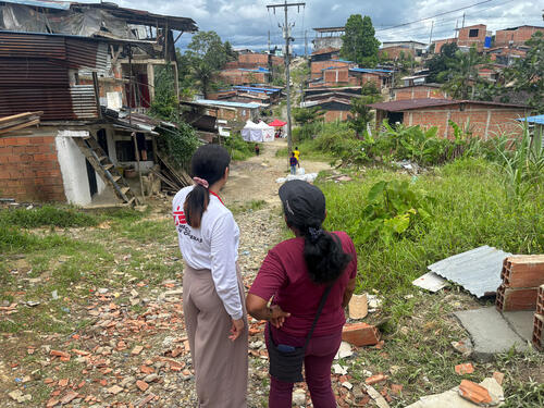 Yohanis Álvarez, a water and Sanitation technician, tours the La Carmelita neighborhood (Buenaventura) with Teresa Bautista, a community leader.