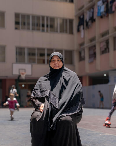 Halime
From Qaaqaaiyet El Jisr, Nabatiyeh
"I just want to reach home and kiss the doorstep."
Halime was born and raised in Beirut, and she doesn't deny her preference for city life. Yet, she deeply longs for her modest house in the village, with its small garden that her husband plants and tends to. Halime was home-loving and rarely left her house unless necessary, but she was warmly hospitable, welcoming visitors at all hours of the day. With the outbreak of the latest escalation of the Israeli war, Halime was forced to leave her home alongside her husband and 13-year-old daughter. Displacement took a heavy toll on Halime, exhausting her body until she was no longer able to stand or walk without help. It also drove her daughter into fear and isolation, especially given the harsh conditions at the public school serving as their shelter in Beirut. Halime closes her eyes and finds herself back on her balcony, which she had transformed into a cozy, tent-lie room with wooden windows where family and friends gathered, summer and winter alike.