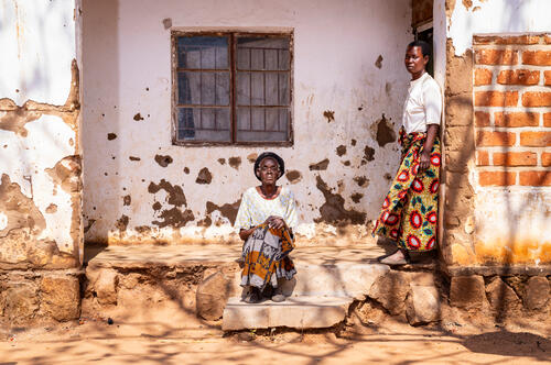 Grace Nyambi and her daughter outside their home in Chileka, in Blantyre district, on July 21, 2026.