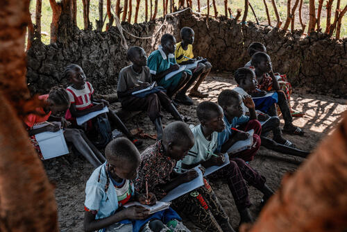 Makeshift school at Bok Chop IDP camp.

“This is a school for refugees. We have very little and need blackboards, books, pencils. The children have to sit on the floor; we don’t have enough mats.” - Michael Kuol, Headmaster.