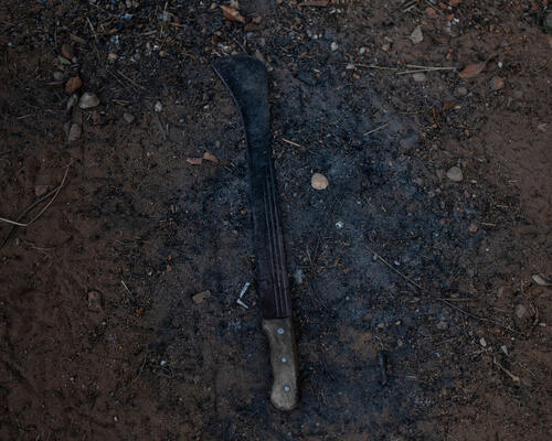 A machete lies on the ground in Mbawa camp