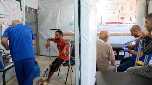 An MSF staff checks the injury of Saad Hussein, who is forced to live with an external fixator after he was injured in 2025 during a food distribution by the Gaza Humanitarian Foundation. Al Mawasi primary healthcare center, Khan Younis, Gaza.