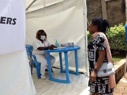 Visitors pass by the coronavirus COVID-19 pre-screening, Bamenda's St Mary Soledad Hospital