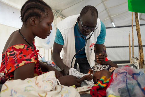 Dr Ran Jal kuol examines a child admitted to the measles isolation ward