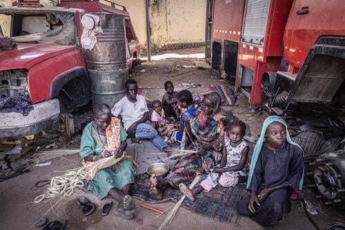 Aissa, 50, with her family sheltering in an abandoned and looted fire station, Zalingei, Sudan.