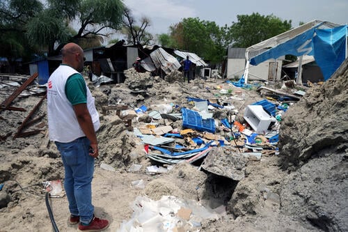 MSF HoM in front of the bombarded warehouse