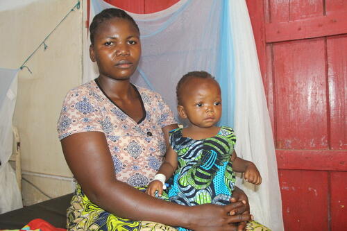 Adelphine in the arms of her mother, Madeleine. She is suffering from malaria and is being treated at the Baraka Hospital, supported by MSF in South Kivu, in the Democratic Republic of Congo.