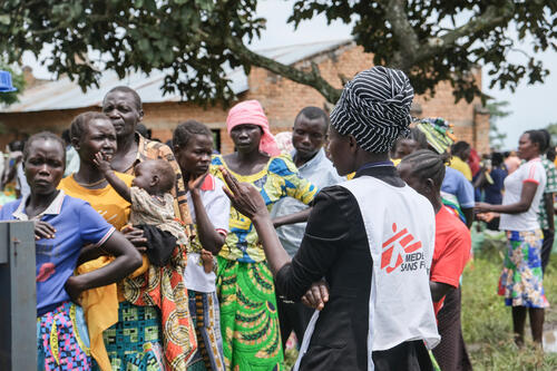 An MSF health promotion agent speaks with South Sudanese refugees in Ulendere village. Malaria remains one of the most prominent health risks facing the community.
