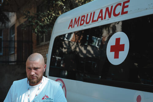 MSF feldsher is next to MSF ambulance in Donetsk region