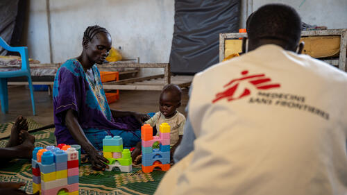 A mother playing with her kid in Phase 2 of MSF’s Inpatient Therapeutic Feeding Center (ITFC) at Kule Refugee Camp for children who are recovering from severe acute malnutrition. August 2025, Gambella , Ethiopia 

“We tried everything, but our child kept getting worse”.  

Testimony from Nyauahial Puoch, mother of 17-month-old Nyakhan, treated at MSF’s inpatient therapeutic feeding centre (ITFC) in Kule. 

My daughter Nyakhan is 17 months old. On July 7, she became very sick—she had a fever, diarrhoea, and vomiting for three days. We tried to care for her at home. We even tried giving her milk, but she wouldn’t take anything. That’s when I knew it was serious. 

I have five children. This is the first time one of them has been malnourished. We’re receiving food distributions including maize, wheat, and sorghum, but it’s only once a month, and it never lasts until the next round. Food is scarce, and the children are hungry before the month ends. 

Before, we used to get more. Now, the packages have been reduced by half, and some items have stopped coming altogether. The reductions began last year, but in the past four months things have gotten even worse. Everyone is struggling. Once the distributions are done, there’s nothing left, and people don’t know where else to turn. 

We have a small piece of land, but it’s not enough. My husband doesn’t have a job. I tried taking Nyakhan to another camp when she got sick, but many of the health services there have been reduced. We were very worried.