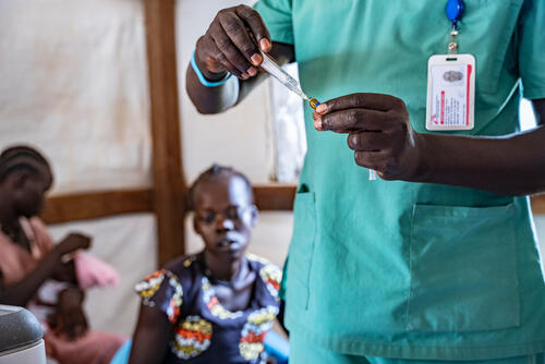 medical staff is preparing the malaria vaccine