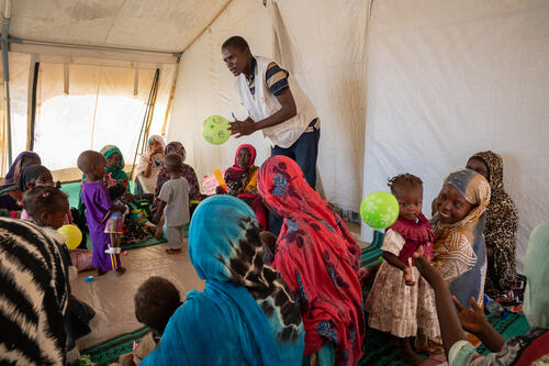 Ouré-Cassoni, Chad - July 23, 2026. MSF psychologist Timothée Awoulzou Tchangvo leads a psychosocial stimulation group session for caregivers and children with moderate acute malnutrition, MSF Outpatient Department, Zone D of the refugee camp. MSF's mental health teams run weekly group sessions for families with malnourished children, using play and interaction to support child development alongside nutritional treatment. Sessions for children with severe acute malnutrition are held on Tuesdays, for children with moderate acute malnutrition on Thursdays. CREDIT: Flurina Rothenberger for Médecins Sans Frontières.