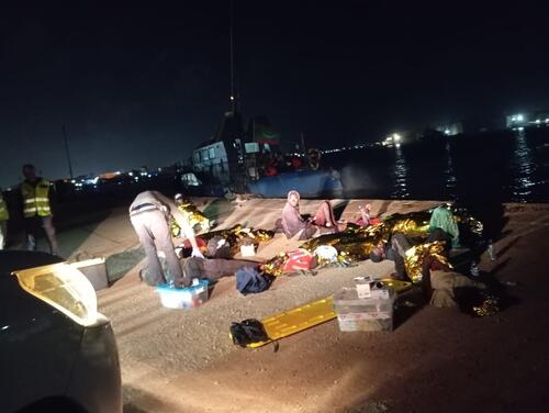 Survivors of boat tragedy resting on the Mauritanian shore during MSF intervention