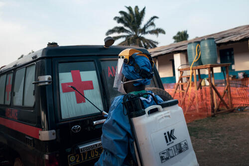 A hygienist at the MSF-operated Ebola Treatment Centre disinfects the doors of an ambulance after it transported a patient, suspected of having Ebola disease, to the admission area of the facility. Mongbwalu, Ituri Province, Democratic Republic of the Congo, 20 June 2026.
