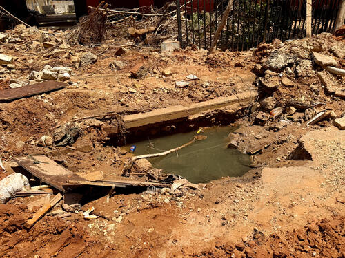 A view of a dirty water-filled area in the street of Burj El Barajneh after an Israeli strike damaged the water infrastructure in March 2026.