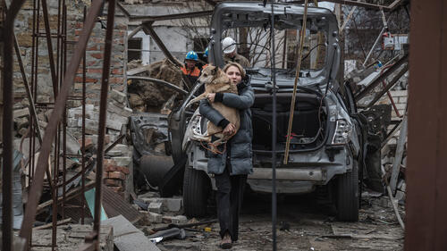MYKOLAIV, UKRAINE - NOVEMBER 17: A local woman carries her wounded dog from the site of a Russian kamikaze drones' strike on the city's residential area on November 17, 2024 in Mykolaiv, Ukraine. In the early morning, the Russian army carried out a kamikaze drone strike on the city, resulting in the destruction of two and damage to at least five residential buildings; stores, non-residential facilities and vehicles. Two women were killed, one of whom was pregnant; seven more people were injured, including two children. (Photo by Serhii Ovcharyshyn/NikVesti.com/Global Images Ukraine via Getty Images)