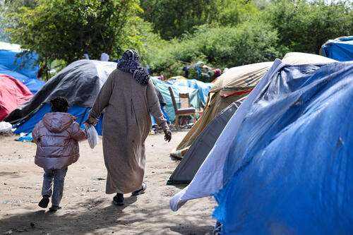 Asylum seekers and their families are using tents in the bushes as shelter.