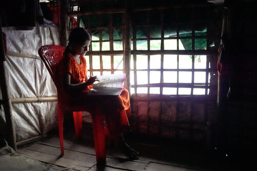 5 A Rohingya girl studies in her shelter