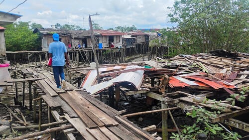 A man walks over the remains of his house in the Santafé neighborhood, one of the most affected by the earthquake in Buenaventura.
