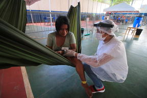 Health team measure the blood pressure of an indigenous Warao woman in an isolation and observation center for people with mild cases of COVID-19.