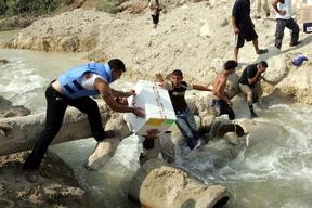 Journalists and MSF staff transporting medical suppllies