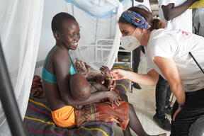 MSF nursing activity manager shares a smile with mother