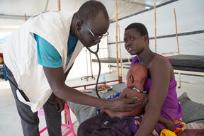Dr Ran Jal kuol examines a child admitted to the measles isolation ward