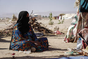 Abdu Sabit sits outside her tent