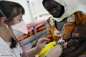Doctor treats a child in Fori hospital