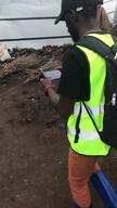Surveyor walking through shelters in an IDP camp