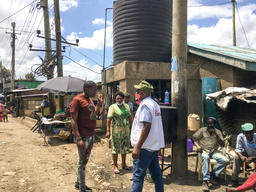 An MSF staff walks past children playing near