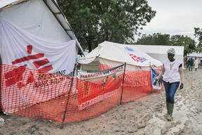 MSF Nurse in Bulukat walks in front of MSF’s Mobile Clinic
