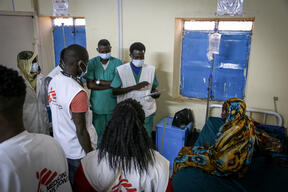 MSF medical team on round checking in on woman in maternity ward