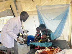 MSF Nurse examines a baby at the inpatient therapeutic feeding centre