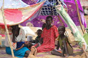 A mother and her children under their temporary shelter