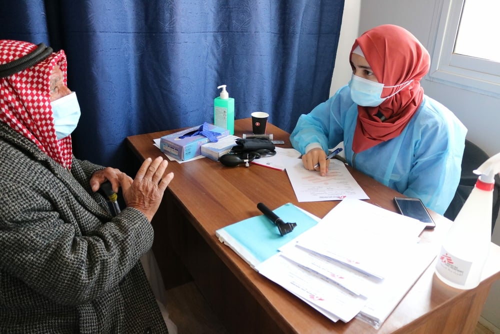 An MSF doctor talks to a patient