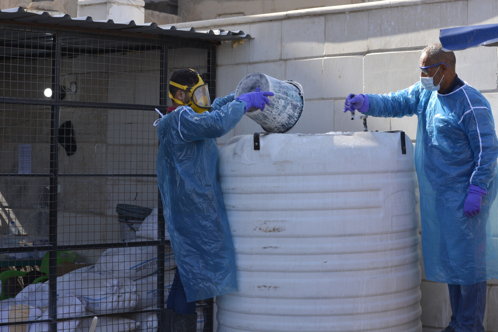 A water and sanitation team mixes lime with fecal sludge from the cholera treatment center in order to eliminate Vibrio cholera, Raqqa, northeast Syria. 03 November 2022.