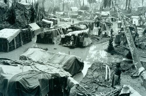 Refugies Rwandais a Tingi Tingi. A partir du mois de septembre 1996, un mouvement rebelle, soutenu par le Rwanda et l’Ouganda, emerge dans le Kivu, region frontaliere de ces deux pays. En octobre et novembre 1996, les troupes rebelles attaquent les camps de refugies rwandais et burundais situes le long de la frontiere du Zaire, provoquant le retour d’une partie d’entre eux vers le Rwanda (entre 400 et 500.000 refugies) et le Burundi (environ 60.000 refugies). Les refugies rwandais, encadres et otages des ex-FAR et interhamwes comme dans les les camps sur la frontiere, sont disperses, pourchasses, perdus dans la foret zairoise. Debut decembre 1996, su l’axe routier Kisangani-Bukavu, un groupe  de 80.000 refugies se regroupe sur le site de Tingi-Tingi, un autre groupe de 20 a 25.000 est localise a Amissi. MSF intervient sur le camp de Tingi Tingi en mettant en place les structures medicales permettant de prendre en charge les pathologies les plus graves (malaria, diarrhee, malnutrition): hopital, centre d’isolement, CNT e CNS, approvisionnement en eau.